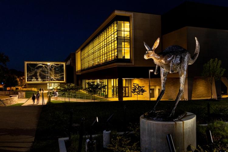 Corbin Roo statue at night with Miller Nichols Library in background
