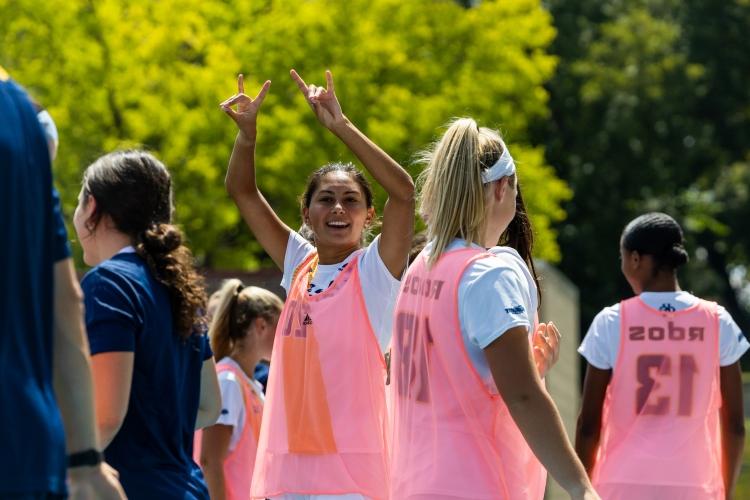 Women's soccer players wear pink jerseys
