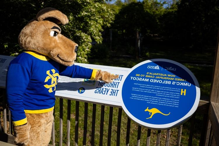 KC Roo points to UMKC signage at Bluey's deck in the Australia section of the Kansas City Zoo